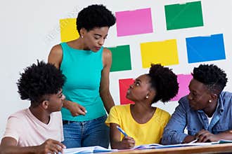African american female teacher talking with students