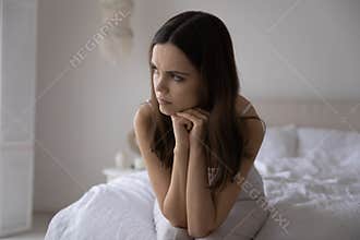 Upset young woman look in distance suffering from breakup
