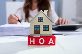 House Model Over HOA Blocks Over Desk In Office