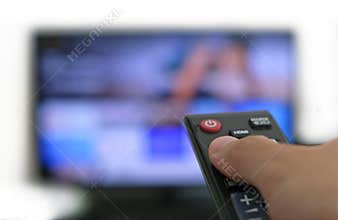 Remote control and screen - binge watching the favourite TV show