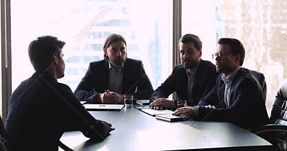 Confident human resources management holding interview with job applicant.