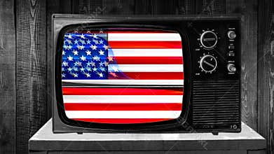Zoom then fixed shot on an old retro television in 70`s 80`s vintage style with american flag on screen with retro glitch effect