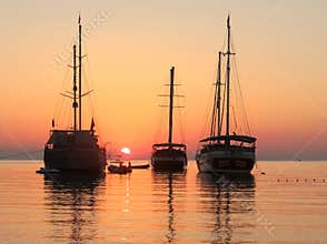 Ships in a Mediterranean sea . Calm sunrise
