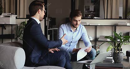 Happy businessmen shaking hands, making agreement in office.