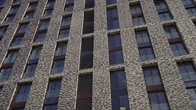 The facade of brick high-rise apartment buildings with stained glass windows.