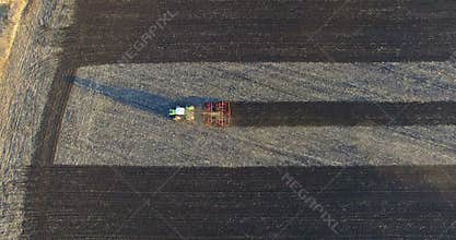 Aerial view to field with one plowing agriculture machine