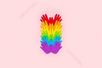 Pride, LGBT flag symbol concept with rainbow color palm hands heart butterfly shape on pink background with copy space