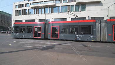 Red and dark brown tram in The Hague city center
