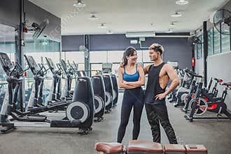 Asian couples posting post a photo with camera so exercise before running on the treadmill.Athletic exercises.Metaphor Fitness and