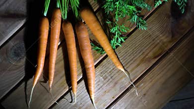 4k. A row of carrots on a rotating wooden table