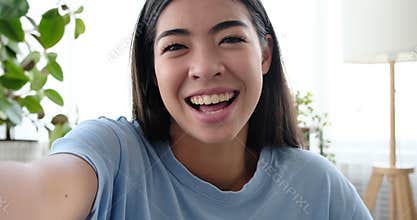 Happy woman greeting and talking on video call