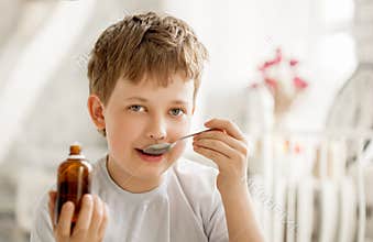 Boy drinking cough syrup
