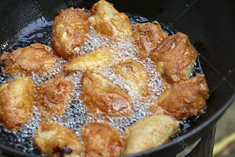 Fried chicken in a pan with hot oil.