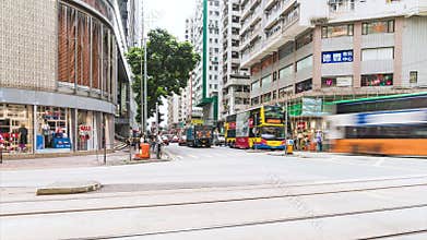 4K motion panning time-lapse of crowded people and car traffic transport across intersection in Hong Kong