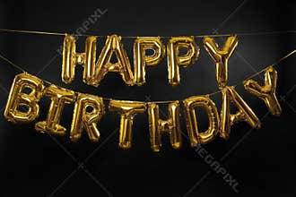 Phrase HAPPY BIRTHDAY made of golden balloon letters