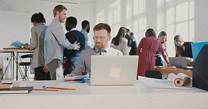 Stressed young office worker man throwing papers in the air, walking away from busy modern office table RED EPIC.