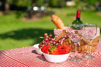 Picnic. bottle of wine with glasses. strawberry.romance. rest and sunny mood
