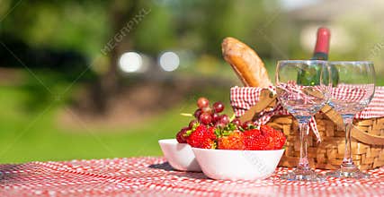 Picnic. bottle of wine with glasses. strawberry.romance. rest and sunny mood