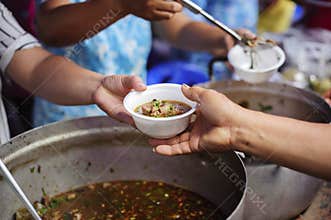 The concept of humanitarianism : The hands of refugees have been aided by charity food to alleviate hunger : Feeding Concepts :