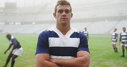 Rugby player standing with arms crossed in stadium 4k