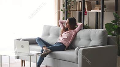 Relaxed girl resting sit on sofa enjoy stress free day