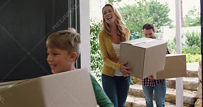 Family with cardboard, boxes entering in a comfortable home 4k