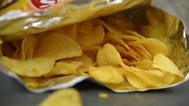 Hand taking potato chips