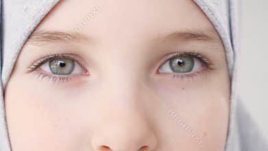 Closeup eyes of muslim teen girl in hijab looking at camera.