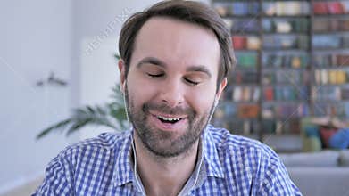 Online video chat  by positive casual beard man, discussing work on webcam