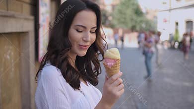 Beautiful brunette woman eating delicious and sweet ice cream
