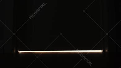 Light is off under a door at home in the night - feet level