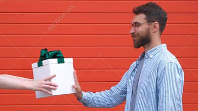 Handsome man shows stop sign with a serious and confident face expression not accepted as a gift box