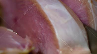 Cook slices the raw turkey meat