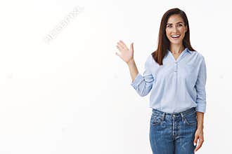 Friendly good-looking european woman entrepreneur with tattoo joyfully welcome you, wave palm gladly invite greet person