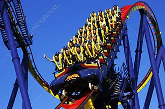 People riding roller coaster