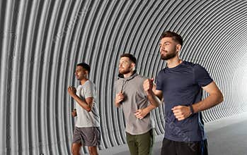 Young men or male friends running outdoors