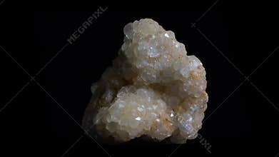 Macro shot of white crystal mineral, close-up shot with rotation. Isolated on black backround.