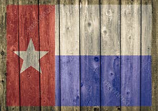 Faded Texas state flag on weathered barn wall