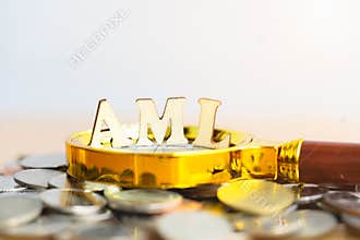 Wood block word AML Anti Money Laundering.