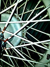 Close up of old time wheel in a old time car with blue lines and metal poles