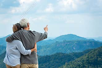 Asian Lifestyle senior couple hug and pointing the mountain nature.  Old people happy in love romantic and relax time.Â 