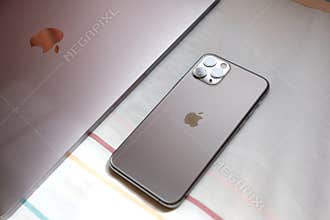 Trang,Thailand. October 25, 2019 : Customer lay down new macbook pro 2019 and iphone 11 pro are space grey colors on bed after rec