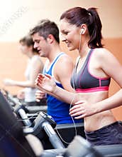 Beautiful female athlete standing on a treadmill