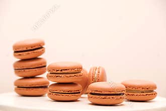 Colorful french macaroons stack on white table. French dessert for birthday paty, celebrations. Trendy color of macaroons