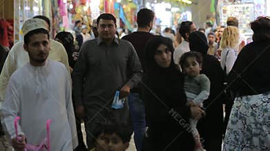 Big east market. Buyers walk along the malls, Muslims in traditional clothes