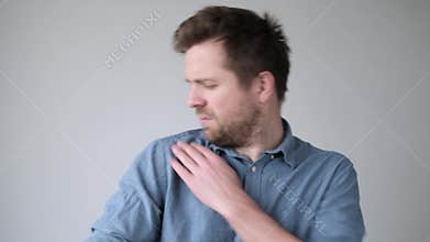 Caucasian mature man dusting off his shoulder.