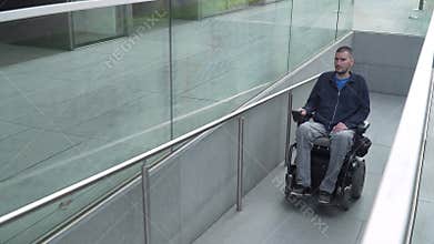 4k resolution follow of a man on electric wheelchair using a ramp. Accessibility concept