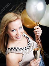 Woman holding new year's champagne and balloons