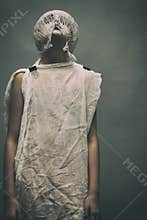 Scary Halloween. Horor. young girl in a strange suit. The face is covered with bound threads