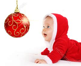 Christmas baby looking at a sparkling red ball